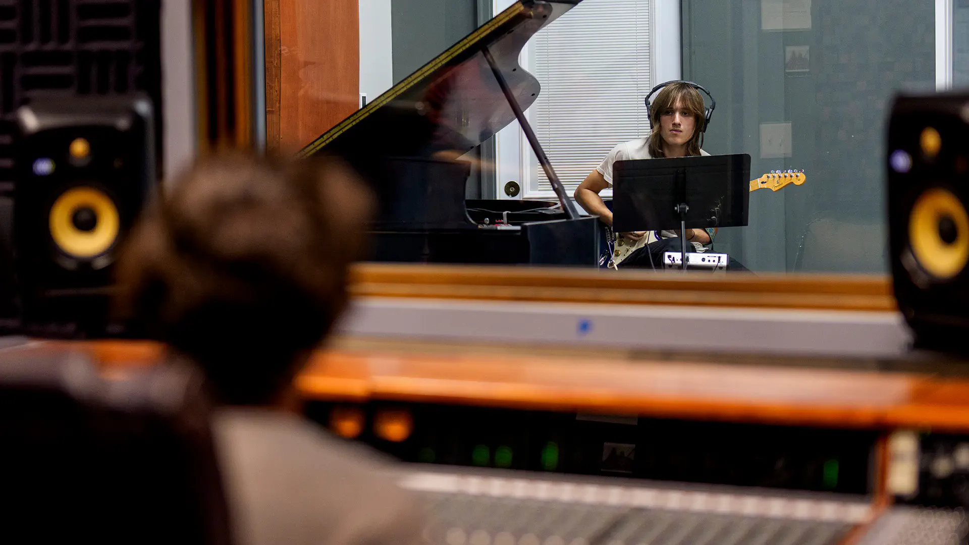 A Music Business and Industry student guitarist lays down a supporting track.