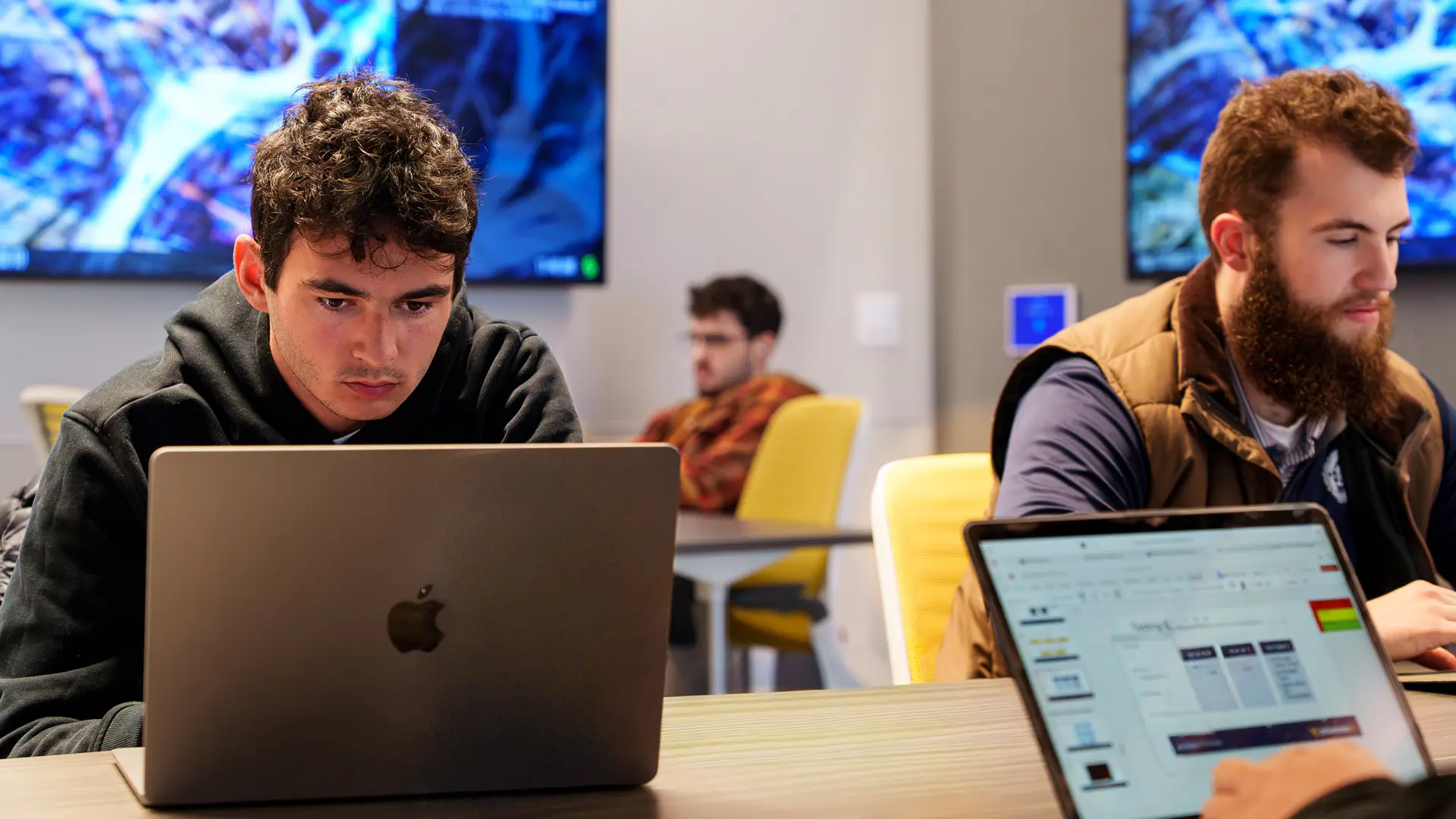 A Student working on his laptop in the Data Analytics Lab in Reynolds Hall.