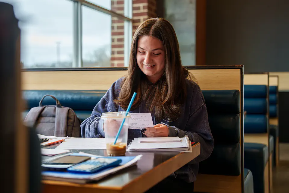 Two students converse while walking near the Health Sciences PRT station.