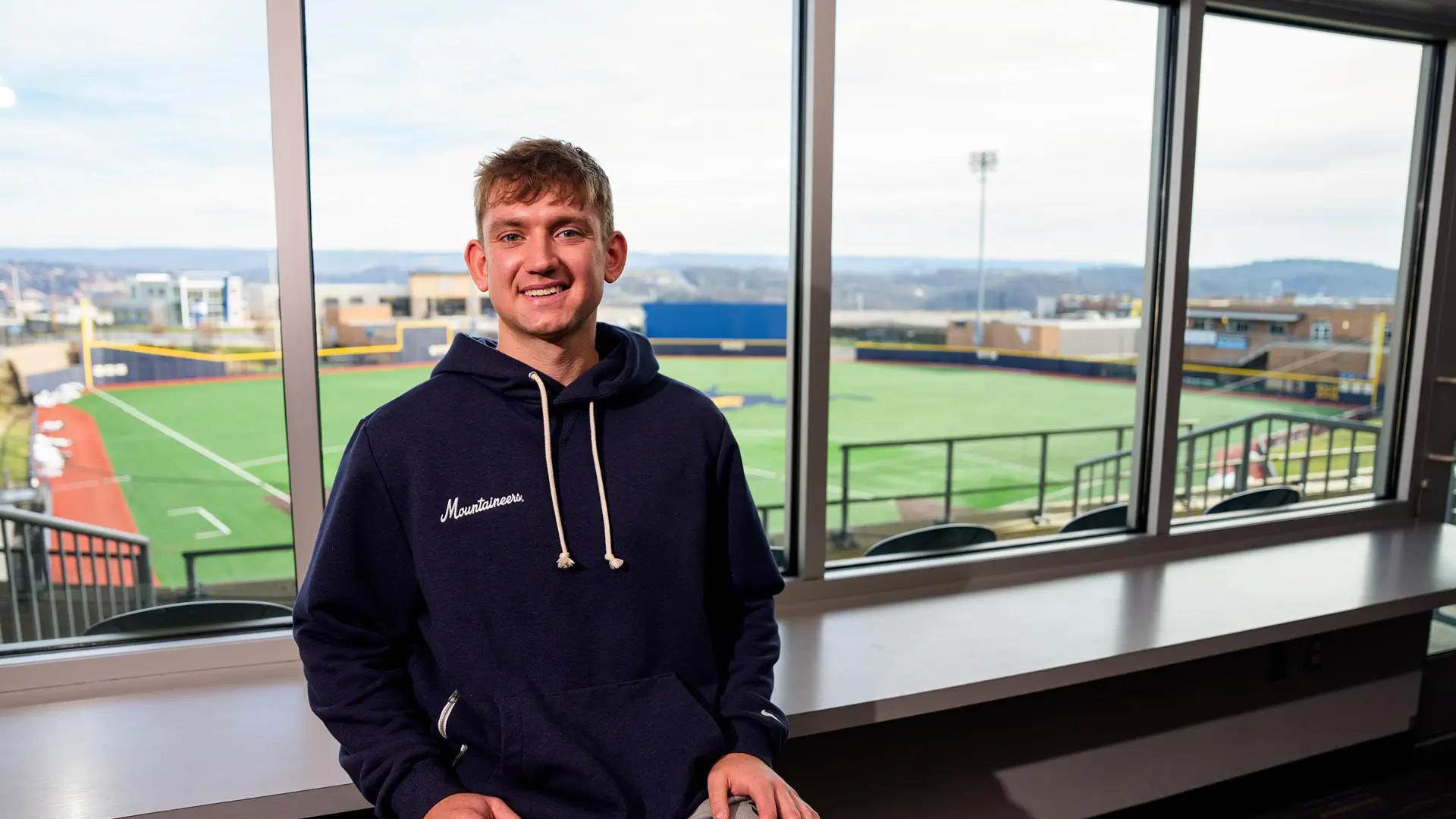 WVU Sport Management senior Nic Menarchek poses for a portrait at the Kendrick Family Ballpark at the Monongalia County Baseball Complex.