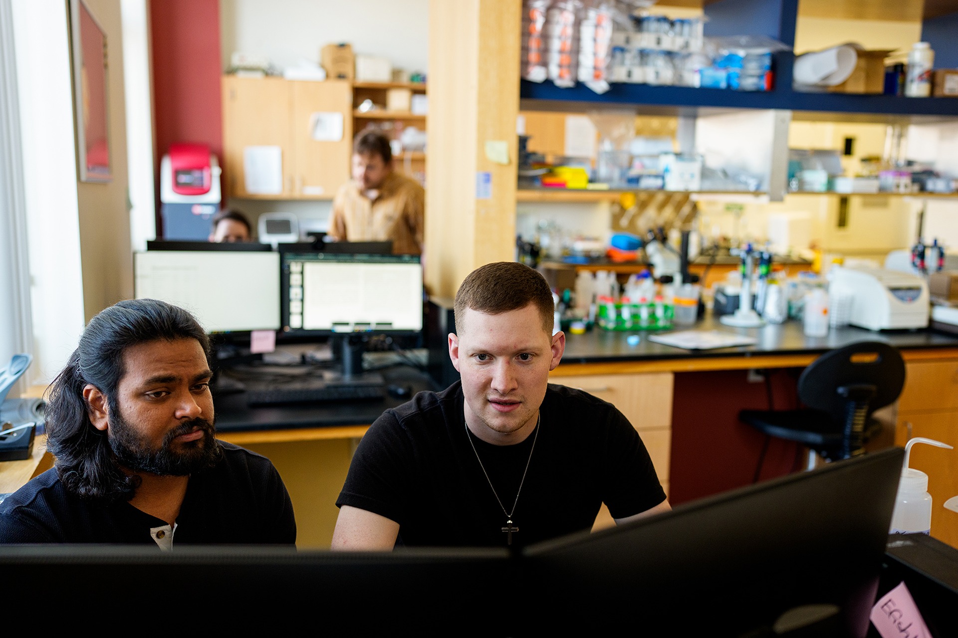 Students working at a computer in a science lab