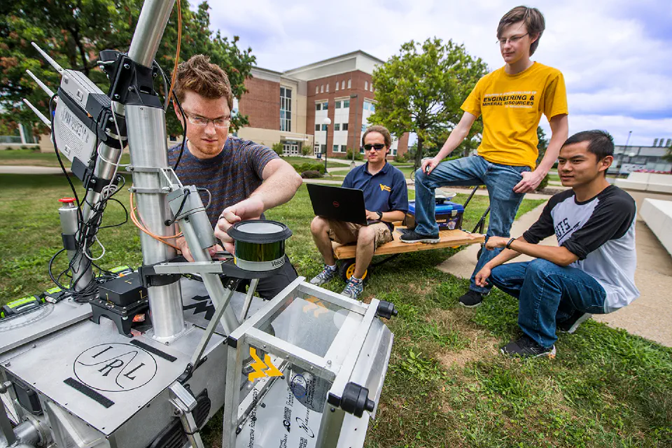 WVU engineering students working on a robotics project outdoors