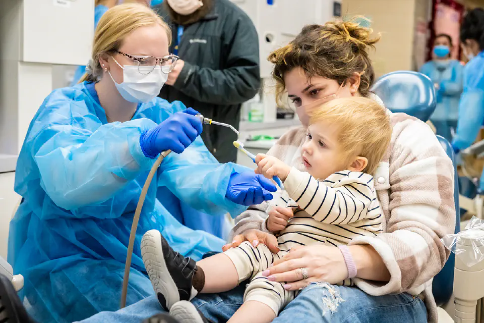 A dental student working with a child at the Pediatric Dentistry Clinic