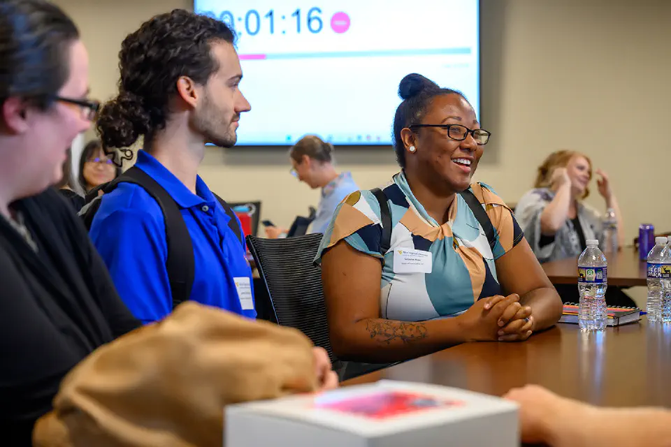 Public Health students talking at a conference table