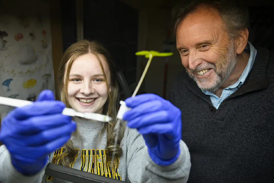 A Davis College student working on a plant sample with a professor