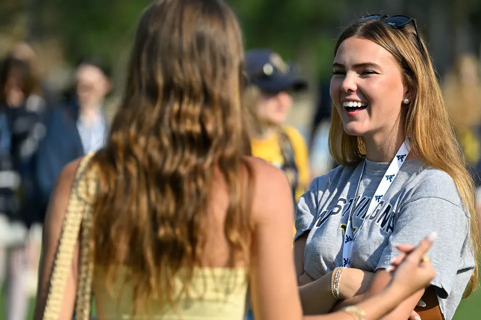 Two people sitting at a round table in a casual indoor setting, engaged in conversation. 
