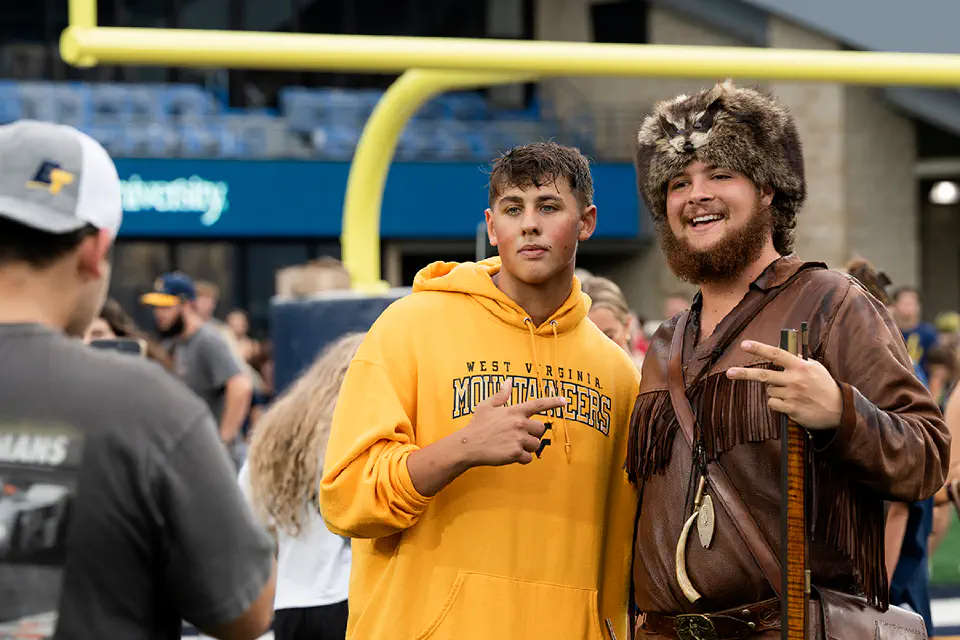 A freshman student posing with the Mountaineer