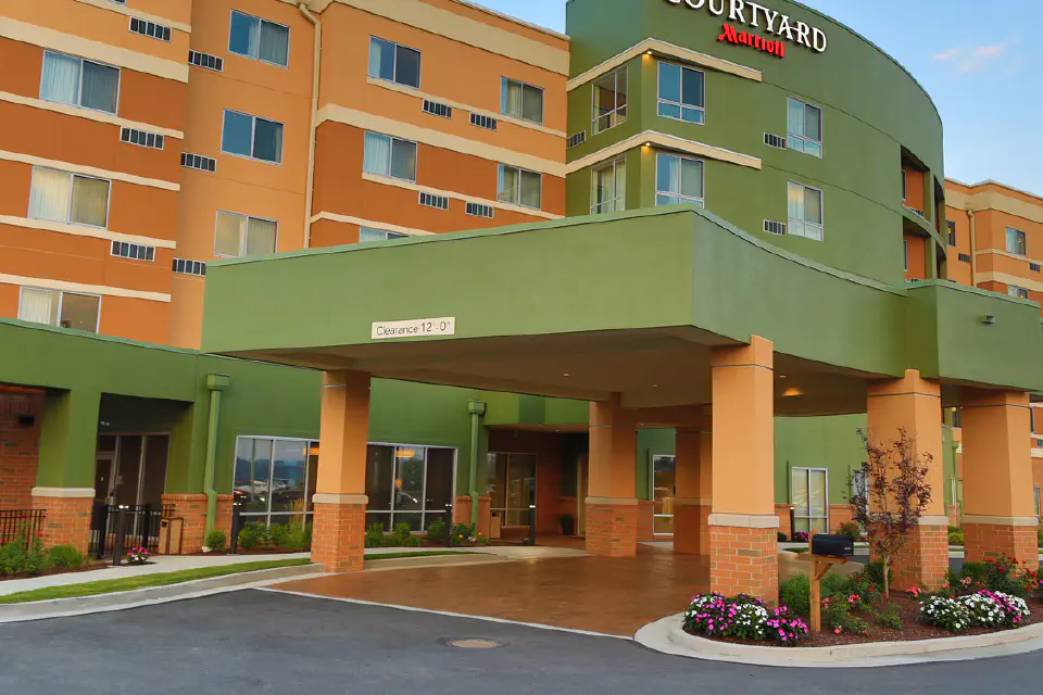 Entrance of modern, 5-story hotel with covered drive-up/unloading area