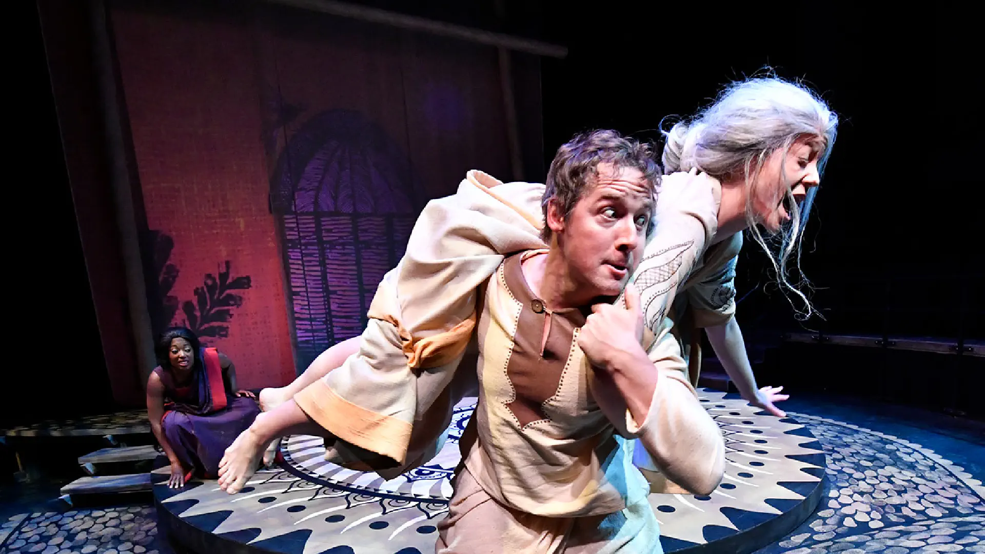 Costumed actors on stage performing