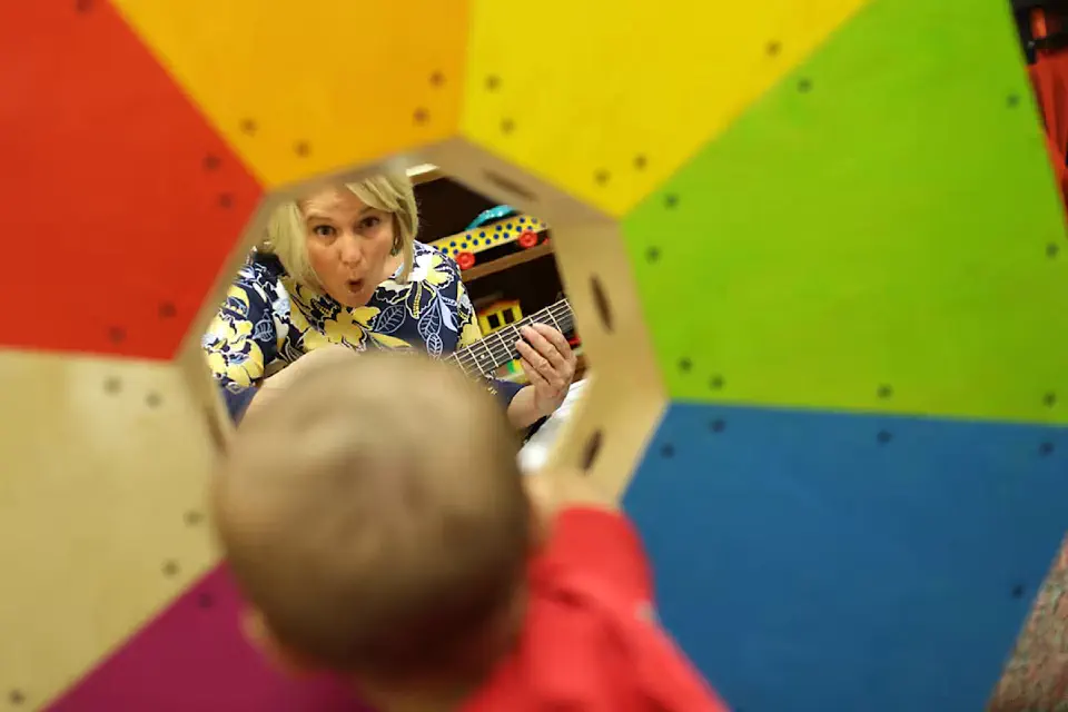 Music therapist interacts with child
