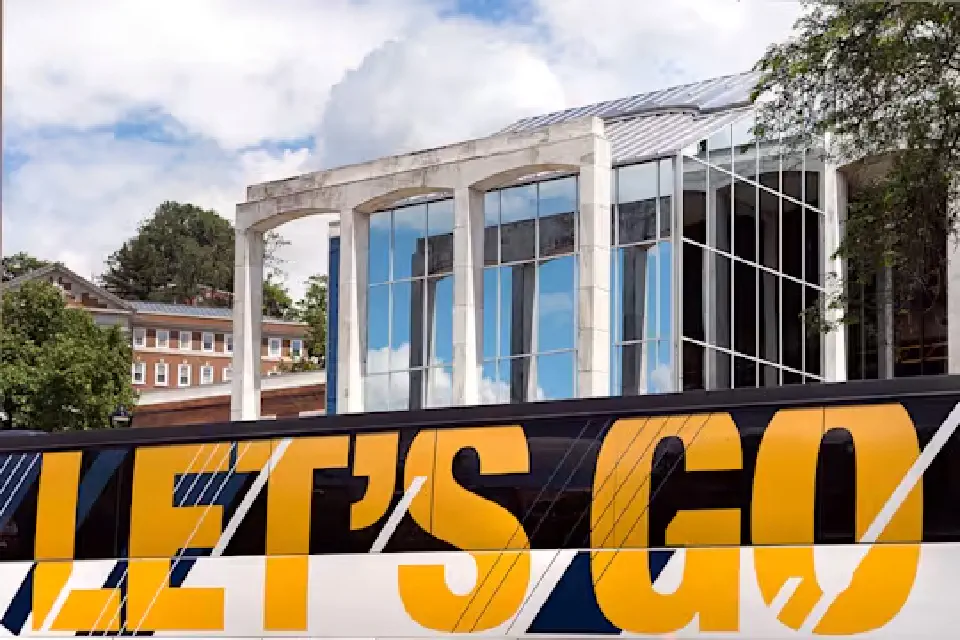 Let's Go banner on side of WVU bus