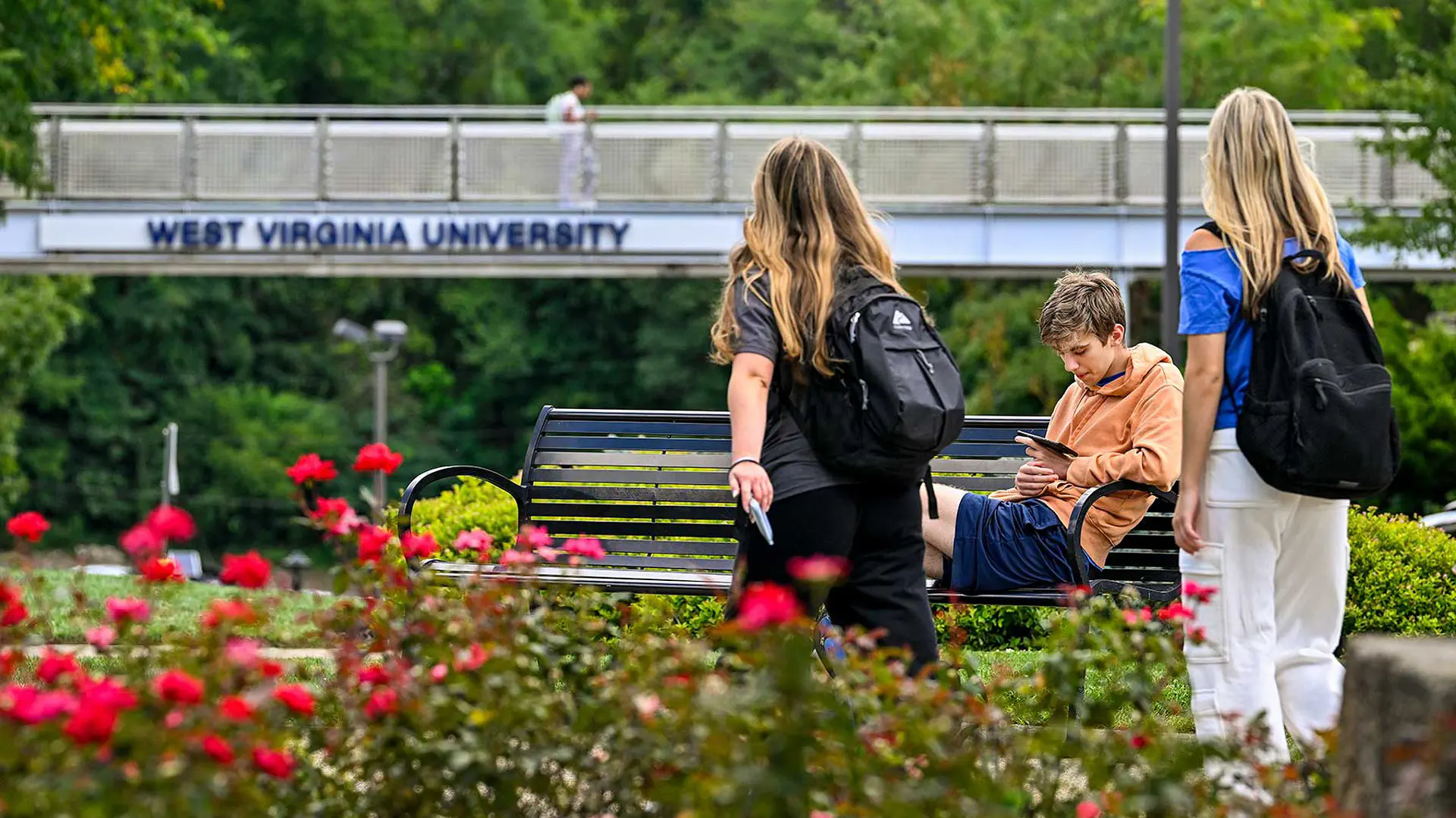 Students walking toward pedestrian bridge on the Downtown area of campus