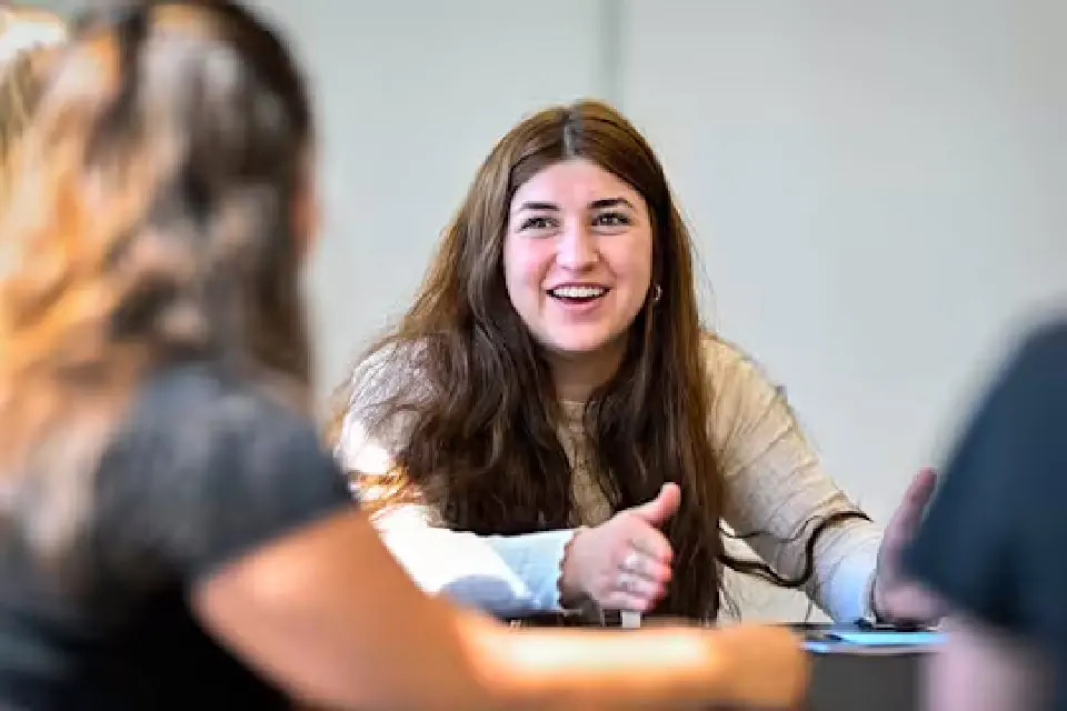 People sitting at a table having a pleasant conversation.