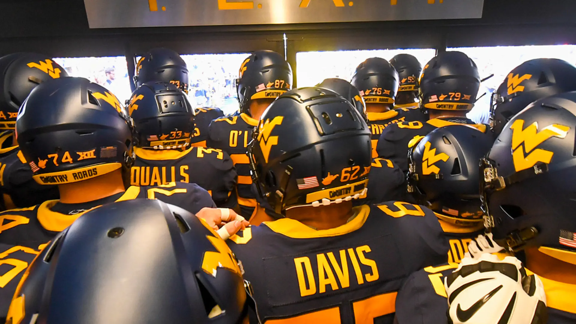 Football players below TEAM sign