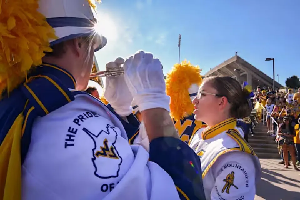 Fans watch as WVU band members warm up outside Milan Puskar Stadium