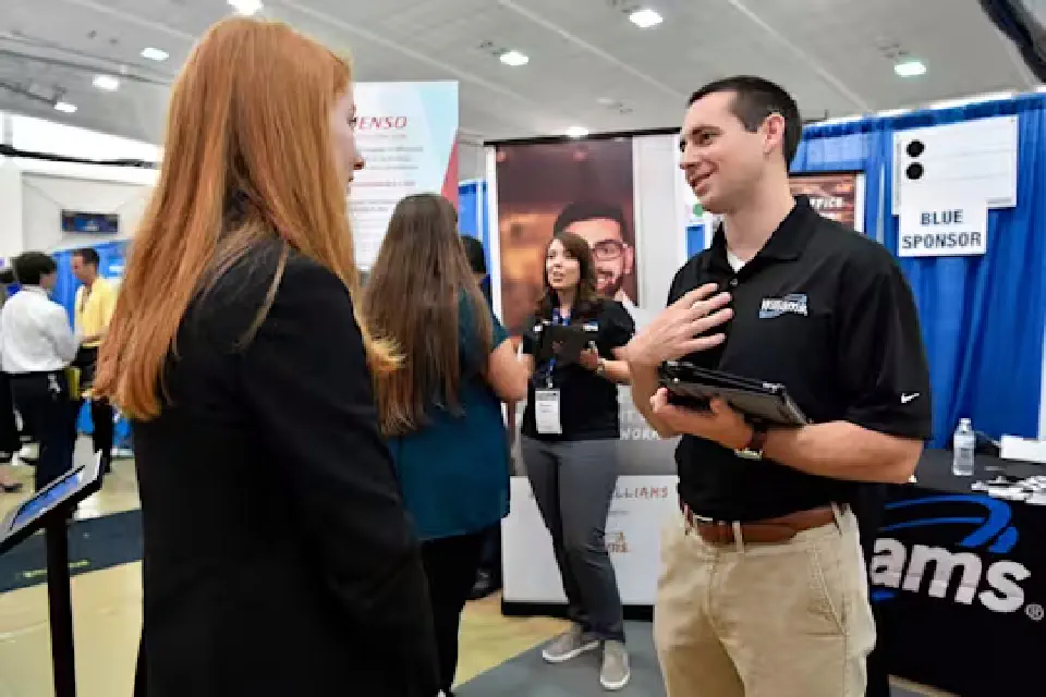 Student talks to a recruiter from Williams at a WVU career fair