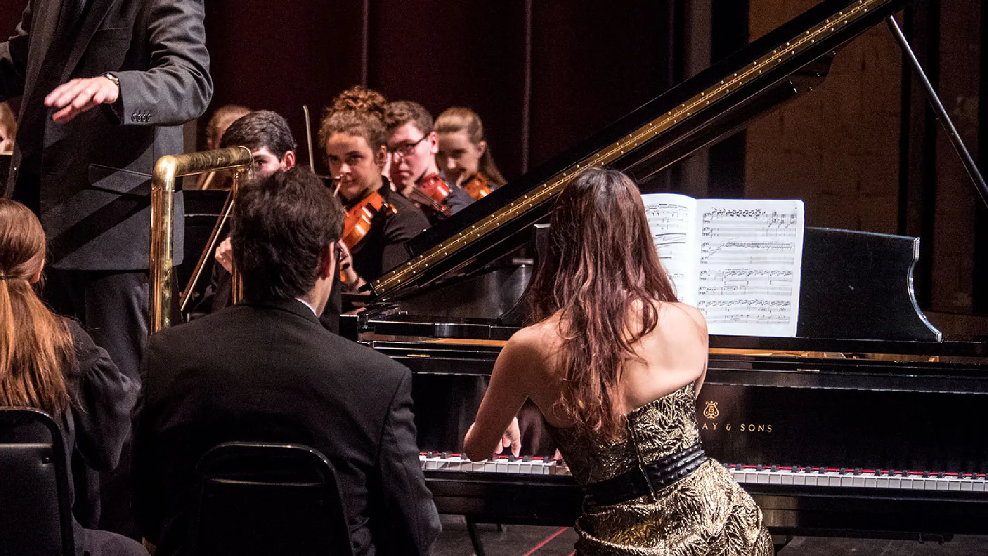 Piano player and symphony orchestra playing on stage at Lyell B. Clay Concert Theatre