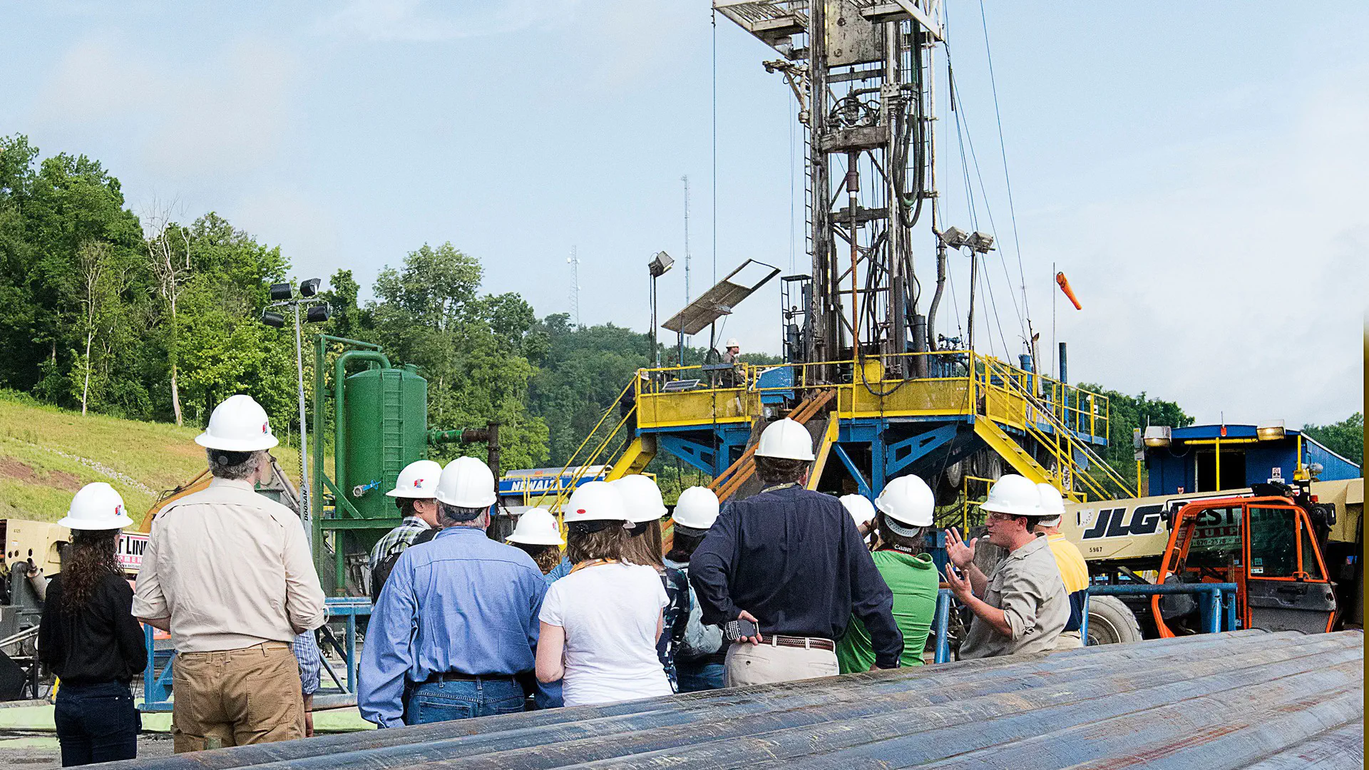 Group touring gas drilling site