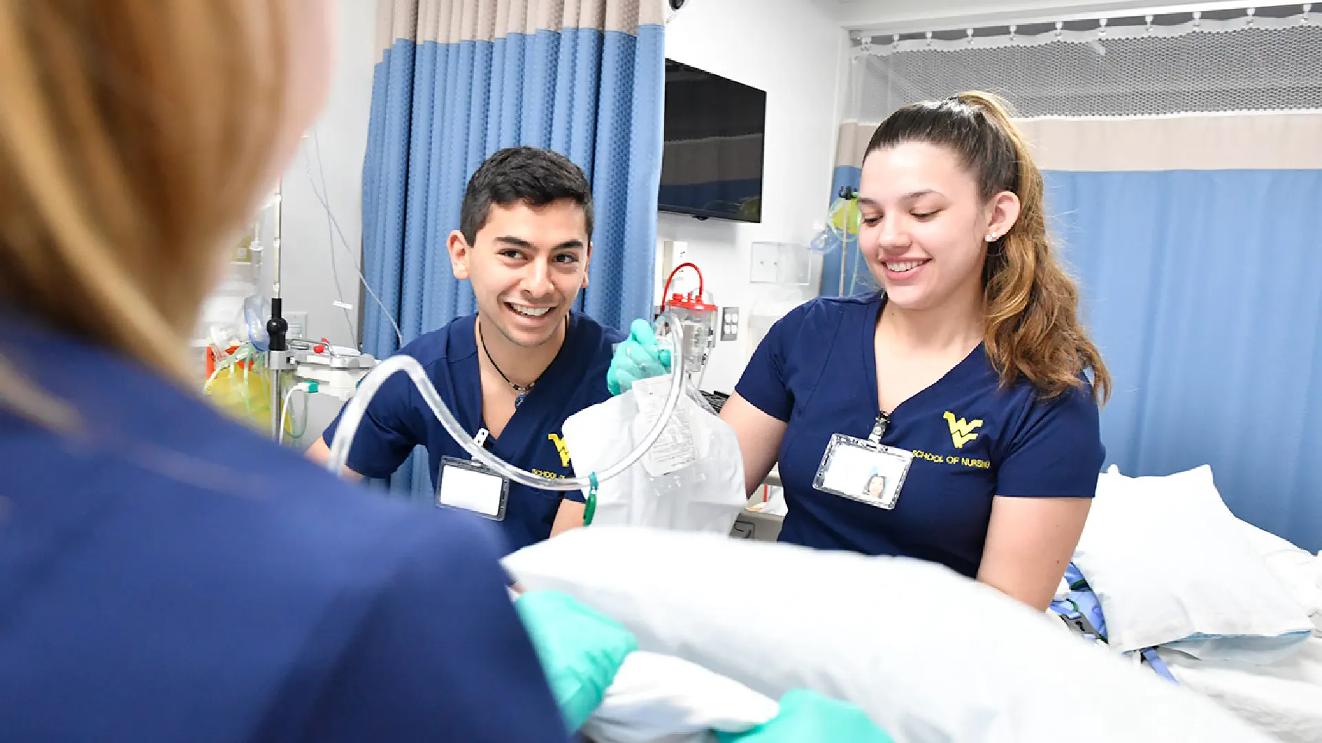 Nursing students smile as they practice procedures