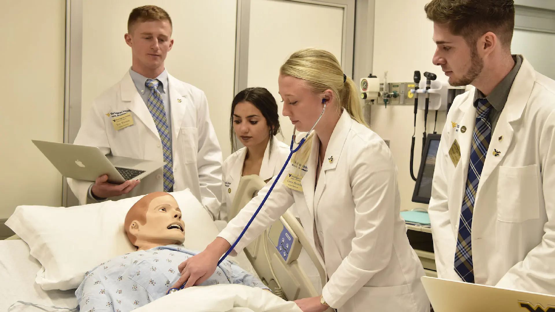 Pharmacy students check vitals in the patient simulation center