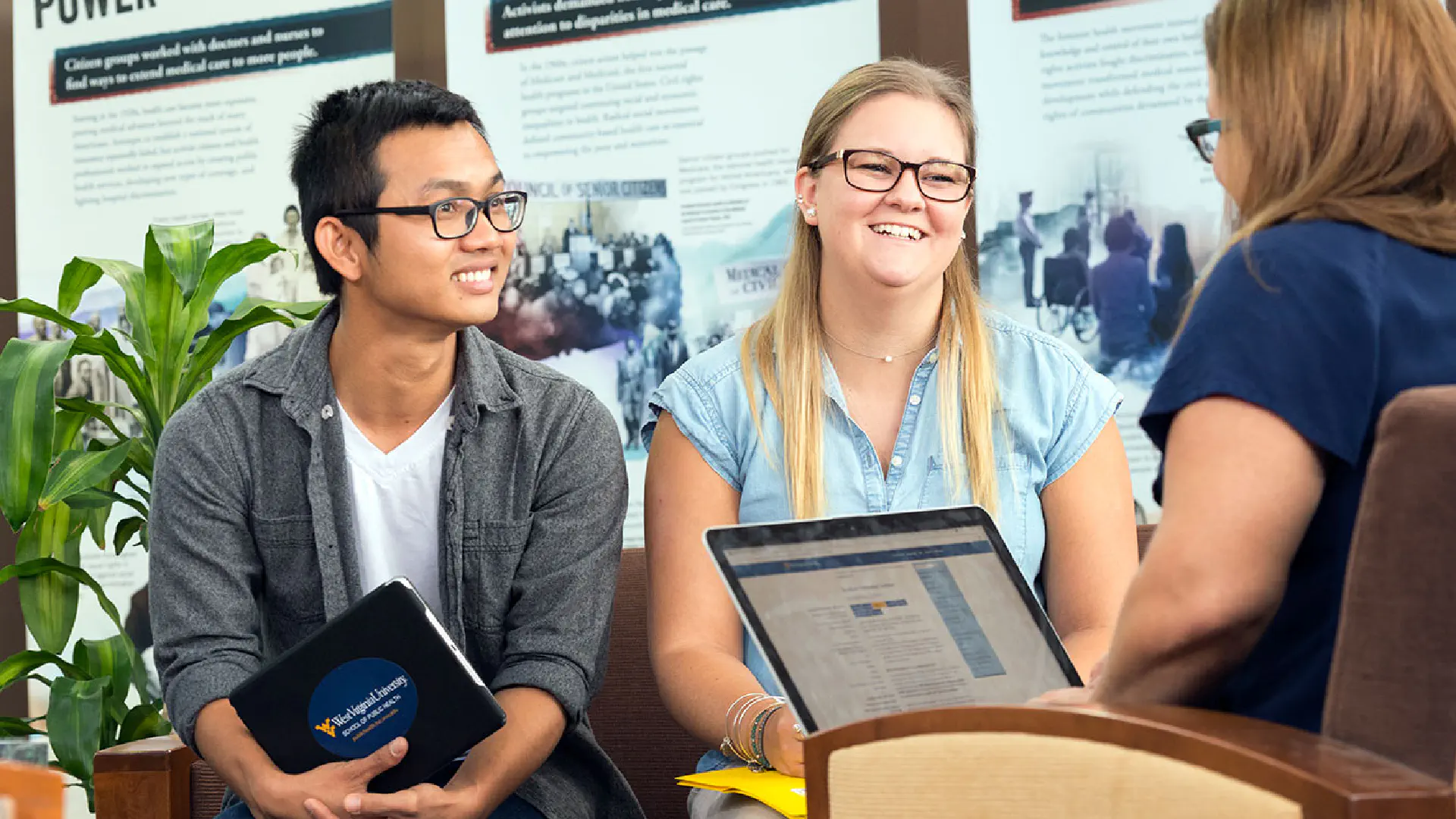 2 School of Public Health students talk with a faculty member