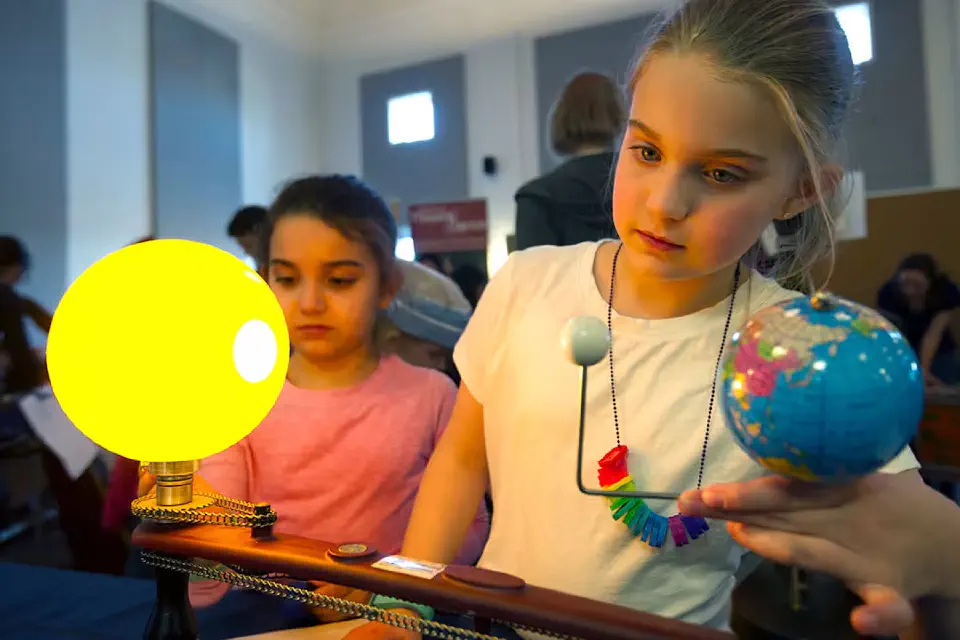 Children examine a model of the solar system