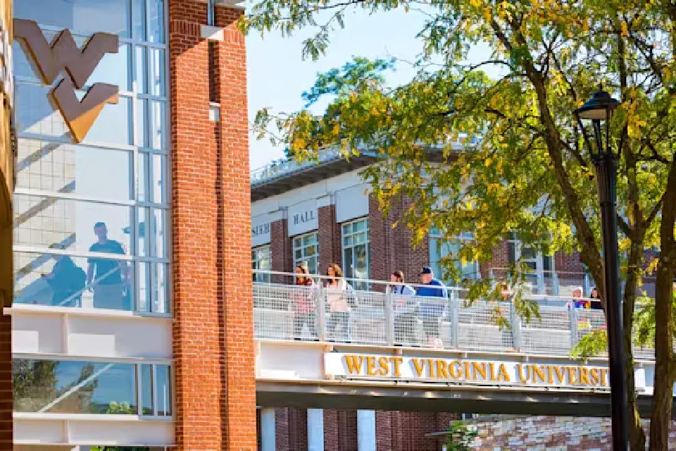Students walk across a pedestrian bridge on the Downtown area of campus.