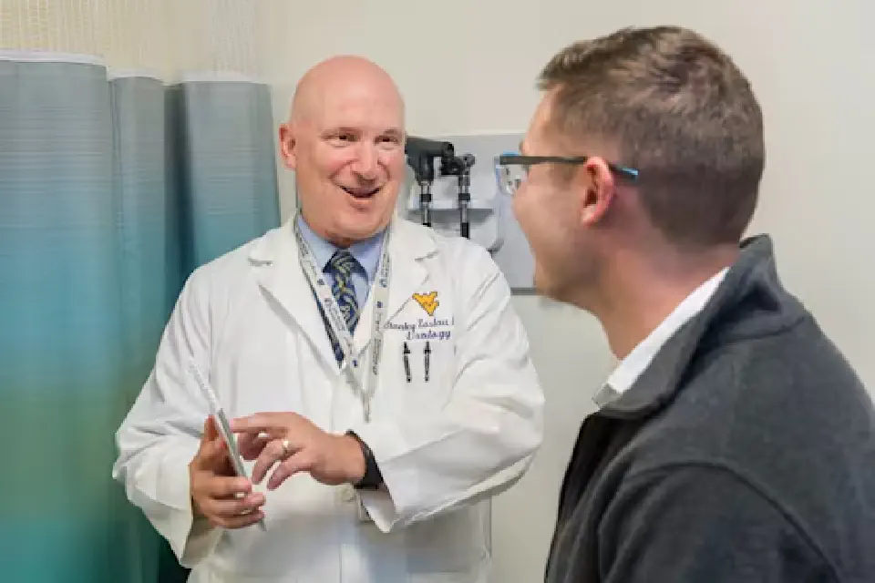 WVU Medicine urologist Stanley Zaslau talks with a patient